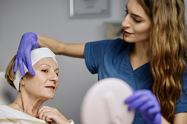 Young female doctor talks about beauty treatments during a consultation with a mature woman patient